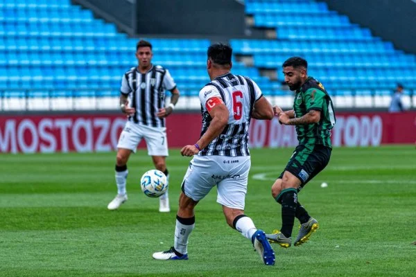 soccer players battling for the ball